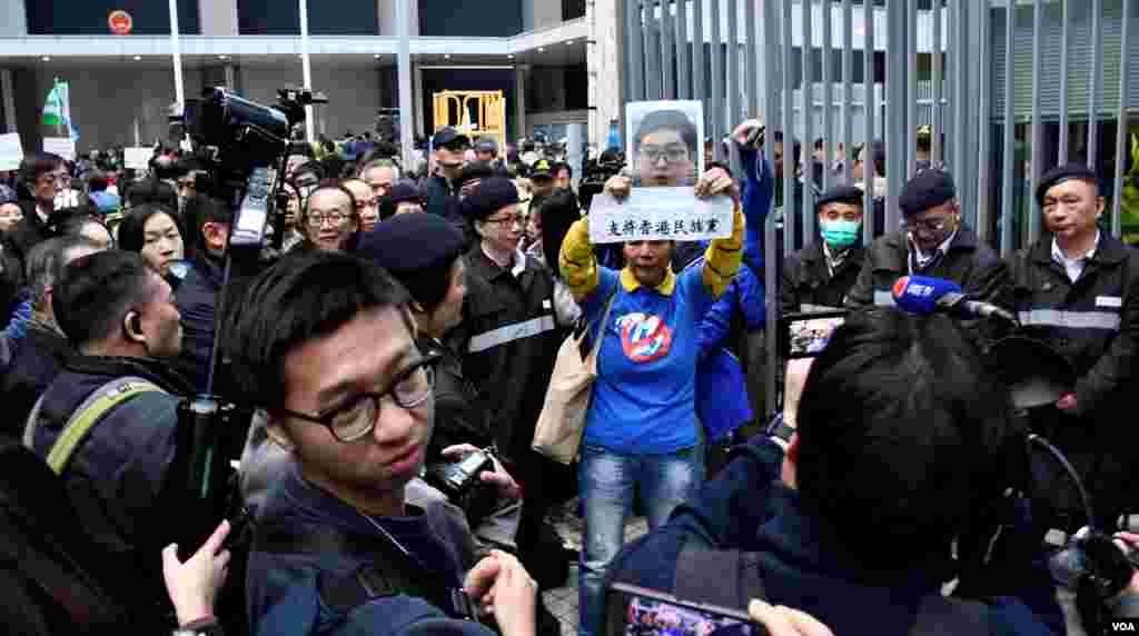 示威者手持支持香港民族黨召集人陳浩天的示威道具，被大批保安人員阻止進入公民廣場。（ 美國之音湯惠芸）