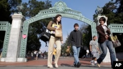 FILE - In this Dec. 14, 2011, photo, University of California Berkeley students walk through Sather Gate on the campus in Berkeley, California. 