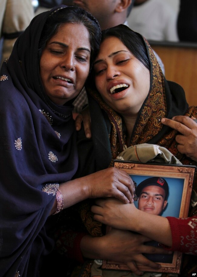 FILE - Pakistani women mourn the death of a family member during a funeral in Karachi, Pakistan, Jan. 18, 2013. The shooting death of Shahzeb Khan, 20, in one of Karachi's most upscale neighborhoods highlighted a growing trend of citizens using social media to hold the country's rich and powerful to account.