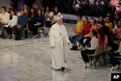 Pope Francis leaves the Paul VI hall at the end of his meeting with youths attending the Synod, at the Vatican, Oct. 6, 2018.