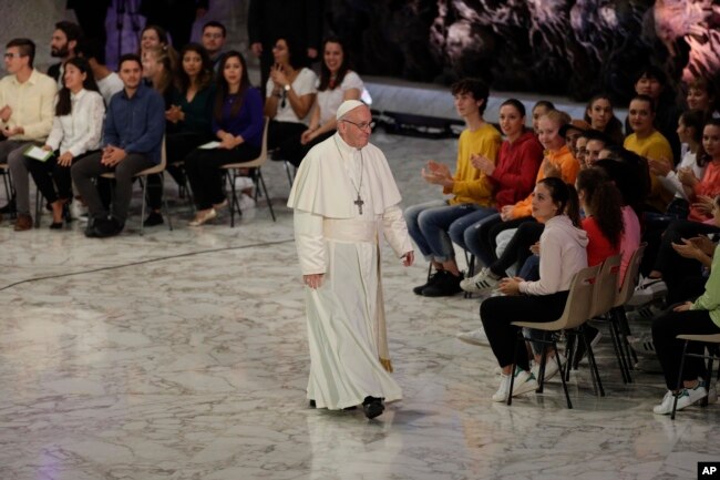 Pope Francis leaves the Paul VI hall at the end of his meeting with youths attending the Synod, at the Vatican, Oct. 6, 2018.