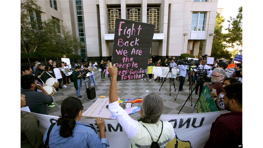 FILE - In this June 20, 2018, photo, protesters demonstrate outside the federal courthouse in Sacramento, Calif., where a judge heard arguments over the U.S. Justice Department's request to block three California laws that extend protections to people in the country illegally. Sacramento is a sanctuary city.