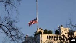 An American flag flies at half-staff in honor of the Connecticut elementary school shooting victims, over the White House in Washington, December 14, 2012.