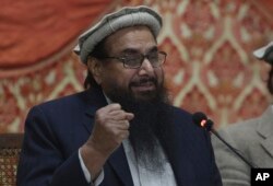 FILE - Pakistani cleric and head of the Jamaat-ud-Dawa charity Hafiz Saeed addresses a news conference in Lahore, Pakistan, Jan. 23, 2018.