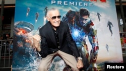 FILE- Stan Lee gestures as he poses at the premiere of "Iron Man 3" at El Capitan theater in Hollywood, California, April 24, 2013.