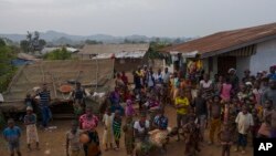 FILE: People look up at a drone photographing them in Komao village, on the outskirts of Koidu, Sierra leone. Taken 11.22.2020