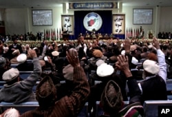 FILE - Members of the Afghan national consultative council known as the Loya Jirga attend the last day of the assembly in Kabul, Afghanistan, Sunday, Nov. 24, 2013