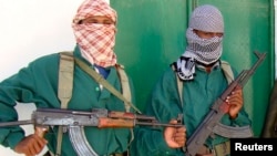FILE - Two al-Shabab fighters are seen in Mogadishu, Somalia, in a 2008 photo.