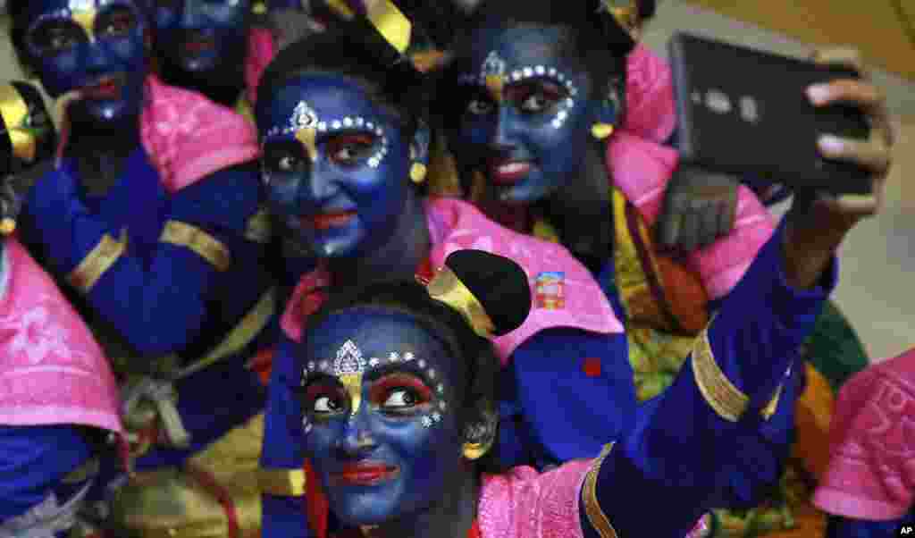 Indian students who got their faces painted in blue take a selfie ahead of Janmashtami celebrations at a college in Mumbai.