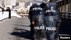 U.S. Custom and Border Protection agents with full riot gear take part in a drill to protect the crossing gates against people who want to cross the border illegally on the international bridge between Mexico and the U.S., in Ciudad Juarez, Mexico, Oct. 29, 2018.