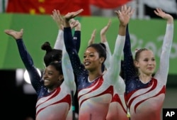 U.S. gymnasts, left to right, Simone Biles, Gabrielle Douglas and Madison Kocian wave to the audience at the end of the artistic gymnastics women's team final at the 2016 Summer Olympics in Rio de Janeiro, Brazil, Aug. 9, 2016.