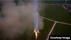 The Falcon 9 Reusable descends slowly back to the launch pad in a still from a video released by SpaceX.