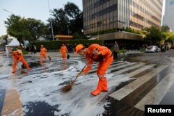 Workers clean the road after a riot outside Indonesia's Election Supervisory Agency headquarters following the announcement of last month's presidential election results in Jakarta, Indonesia, May 23, 2019.