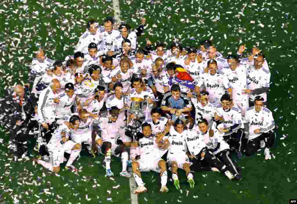April 20: Real Madrid players celebrate with the trophy after beating FC Barcelona 1-0 during the final of the Copa del Rey soccer match in Valencia, Spain. (AP/Pool)