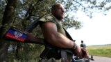 A pro-Russian separatist rebel guards a checkpoint near the village of Rozsypne in Ukraine's eastern Donetsk region August 4, 2014. 