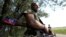 A pro-Russian separatist rebel guards a checkpoint near the village of Rozsypne in Ukraine's eastern Donetsk region August 4, 2014. 