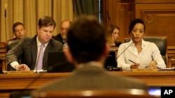Mark Farrell, left, and Malia Cohen, right, listen as Scott Wiener, foreground, speaks during a San Francisco Board of Supervisors meeting at City Hall in San Francisco, Tuesday, April 5, 2016. San Francisco has approved a measure making it the first place in the nation to require businesses to provide fully paid leave for new parents.