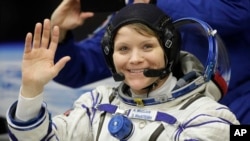 U.S. astronaut Anne McClain waves before the launch of Soyuz MS-11 space ship at the Russian-leased Baikonur cosmodrome, Kazakhstan, Dec. 3, 2018.