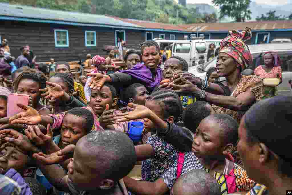People who fled Goma, Congo, gather at a food distribution point in Sake, some 25 kms (16 miles) west of Goma, where they found shelter following an official evacuation order five days after Mount Nyiragongo erupted. 