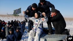 U.S. astronaut Randy Bresnik is being pulled from a Russian Soyuz MS-05 space capsule shortly after it landed about 150 km (80 miles) south-east of the town of Zhezkazgan, Kazakhstan, Dec. 14, 2017.