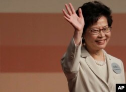 FILE - Former Hong Kong Chief Secretary Carrie Lam declares her victory in the chief executive election in Hong Kong, March 26, 2017.