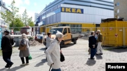 FILE - People walk past IKEA's first city center store in Hamburg, Germany.