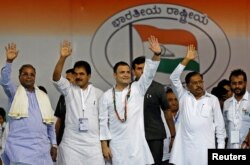 Rahul Gandhi, center, president of India's main opposition Congress party, waves to the crowd before addressing an election campaign rally ahead of the Karnataka state assembly elections, in Bengaluru, India, April 8, 2018.