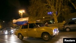 Motorist displays Russian flags ahead of referendum widely expected to transfer control of Black Sea peninsula from Ukraine to Moscow, Sevastopol, March 15, 2014.