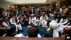 FILE - Mullah Abdul Ghani Baradar, the Taliban group's top political leader, left, Sher Mohammad Abbas Stanikzai, the Taliban's chief negotiator, second left, and other members of the Taliban delegation speak to reporters prior to their talks in Moscow, R