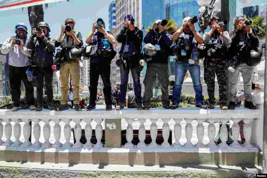 News photographers cover the march of miners supporting Bolivia's President Evo Morales in La Paz, Bolivia.