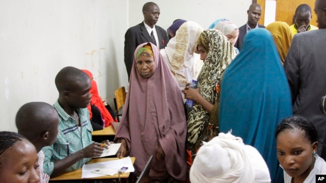 Detained Somali women are fingerprinted and screened at the Kasarani sports stadium, which has been converted into a detention facility to hold those arrested during recent security crackdowns, near Nairobi, April 9, 2014.