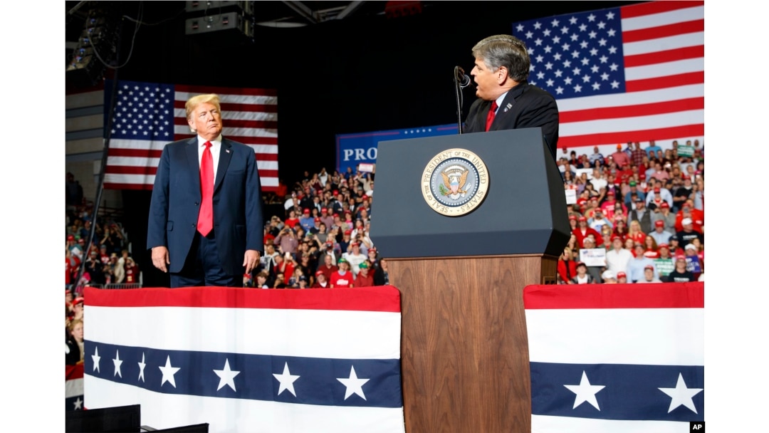 FILE - President Donald Trump listens Fox News' Sean Hannity during a rally in Cape Girardeau, Mo., Nov. 5, 2018. In a June 2024 interview with Hannity, Trump said he "would have every right" to seek revenge against his political opponents.