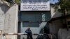 A man walks past the now closed Women's Affairs Ministry building in Kabul, Afghanistan, Sept. 18, 2021. The Taliban set up a ministry for the "propagation of virtue and the prevention of vice" in the building.