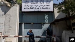 A man walks past the now closed Women's Affairs Ministry building in Kabul, Afghanistan, Sept. 18, 2021. The Taliban set up a ministry for the "propagation of virtue and the prevention of vice" in the building.