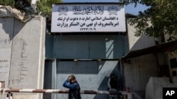 A man walks past the now closed Women's Affairs Ministry building in Kabul, Afghanistan, Sept. 18, 2021.