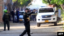 A police officer gestures near the site of an explosion near the Camilo Daza Airport in Cúcuta