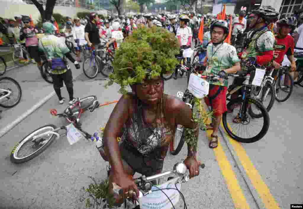 A costumed woman rides her bike during the 15th tour of the fireflies in Pasig city, metro Manila, Philippines. The annual tour of the fireflies advocates clean air and healthy living by promoting bicycles as the main mode of transportation. This year&#39;s tour aims to raise funds to benefit to the victims of supertyphoon Haiyan.
