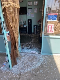 This file photo provided by Jaroenporn Hacker shows the glass door that was smashed and broken into the Thai Spa &Acupuncture, a Thai massage shop in Chatsworth, CA, early August 9, 2021.