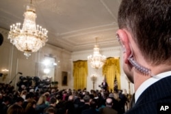 FILE - A Secret Service agent stands as President Donald Trump speaks during a news conference in the East Room of the White House in Washington, Feb. 16, 2017.