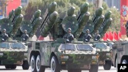 China's missiles are carried through Beijing's Tiananmen Gate during a military parade marking China's 60th anniversary in Beijing, China. (AP Photo/Vincent Thian)