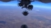 FILE - An image grab made from a video released Oct. 5, 2015, by the Russian Defense Ministry reportedly shows a Russian aircraft dropping bombs during an airstrike against Islamic State group's positions at an undisclosed location in Syria. 