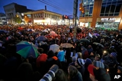 A crowd gathers at the intersection of Murray and Forbes Avenues in the Squirrel Hill section of Pittsburgh during a memorial vigil for the victims of the shooting at the Tree of Life Synagogue, Oct. 27, 2018.