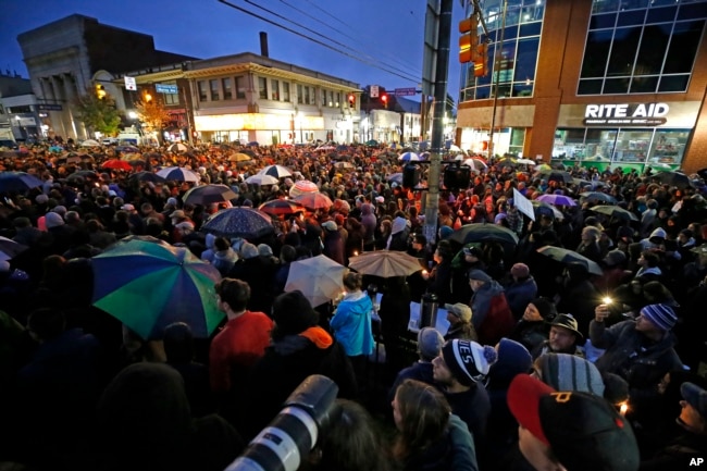 A crowd gathers at the intersection of Murray and Forbes Avenues in the Squirrel Hill section of Pittsburgh during a memorial vigil for the victims of the shooting at the Tree of Life Synagogue, Oct. 27, 2018.