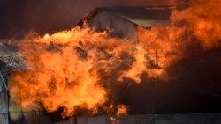 A building burns in Chinatown, Honiara, Solomon Islands, Friday, Nov. 26, 2021. (AP Photo/Piringi Charley)
