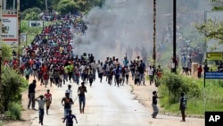 Protestors gather on the streets during demonstrations over the hike in fuel prices in Harare, Zimbabwe, Monday, Jan. 14, 2019. 