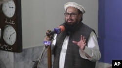 FILE - Hafiz Saeed, head of the Pakistani religious party, Jamaat-ud-Dawa, gives Friday sermon at a mosque in Lahore, Pakistan, Nov. 24, 2017.