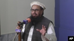 Hafiz Saeed, head of the Pakistani religious party, Jamaat-ud-Dawa, gives Friday sermon at a mosque in Lahore, Pakistan, Nov. 24, 2017.