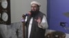 FILE - Hafiz Saeed, head of the Pakistani religious party Jamaat-ud-Dawa delivers a sermon at a mosque in Lahore, Pakistan, Nov. 24, 2017. Saeed has announced his group will field candidates in national and provincial elections in 2018.