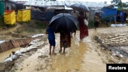 FILE - People walk after a storm at Balukhali refugee camp in Cox's Bazar, Bangladesh, June 10, 2018, in this image obtained from social media. 