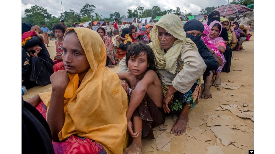 Rohingya Muslims, who recently crossed over from Myanmar into Bangladesh, wait for their turn to receive food aid near Balukhali refugee camp, Bangladesh, Friday, Sept. 15, 2017.